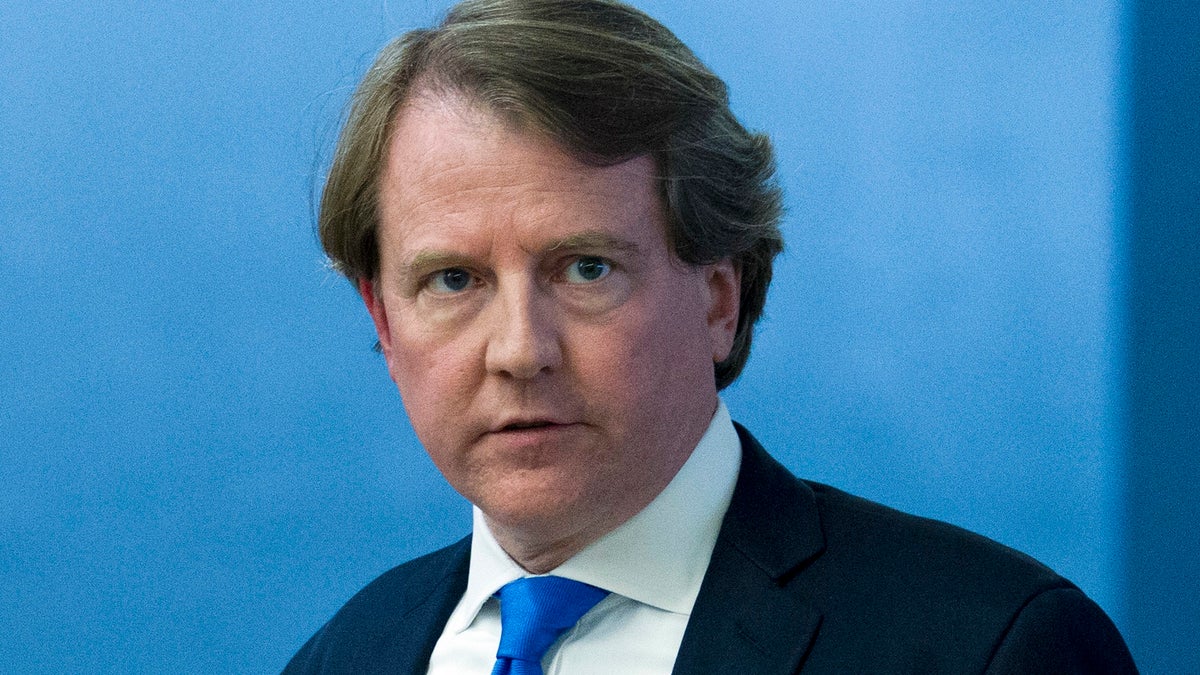 In this Aug. 21, 2018 photo, White House counsel Don McGahn, follows Supreme Court nominee Judge Brett Kavanaugh to meetings on Capitol Hill in Washington.  President Donald Trump is tweeting that his White House counsel, Don McGahn, will be departing in the fall after the Senate confirmation vote for Judge Brett Kavanaugh to serve on the Supreme Court.  (AP Photo/Jose Luis Magana)