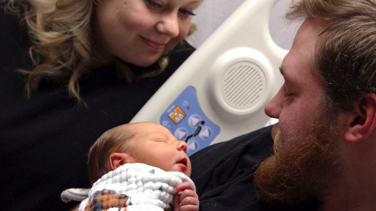 In this Tuesday, Oct. 23, 2018, photo Andrew Goette and his wife, Ashley, look at their baby, Lennon, at United Hospital in Saint Paul, Minn.