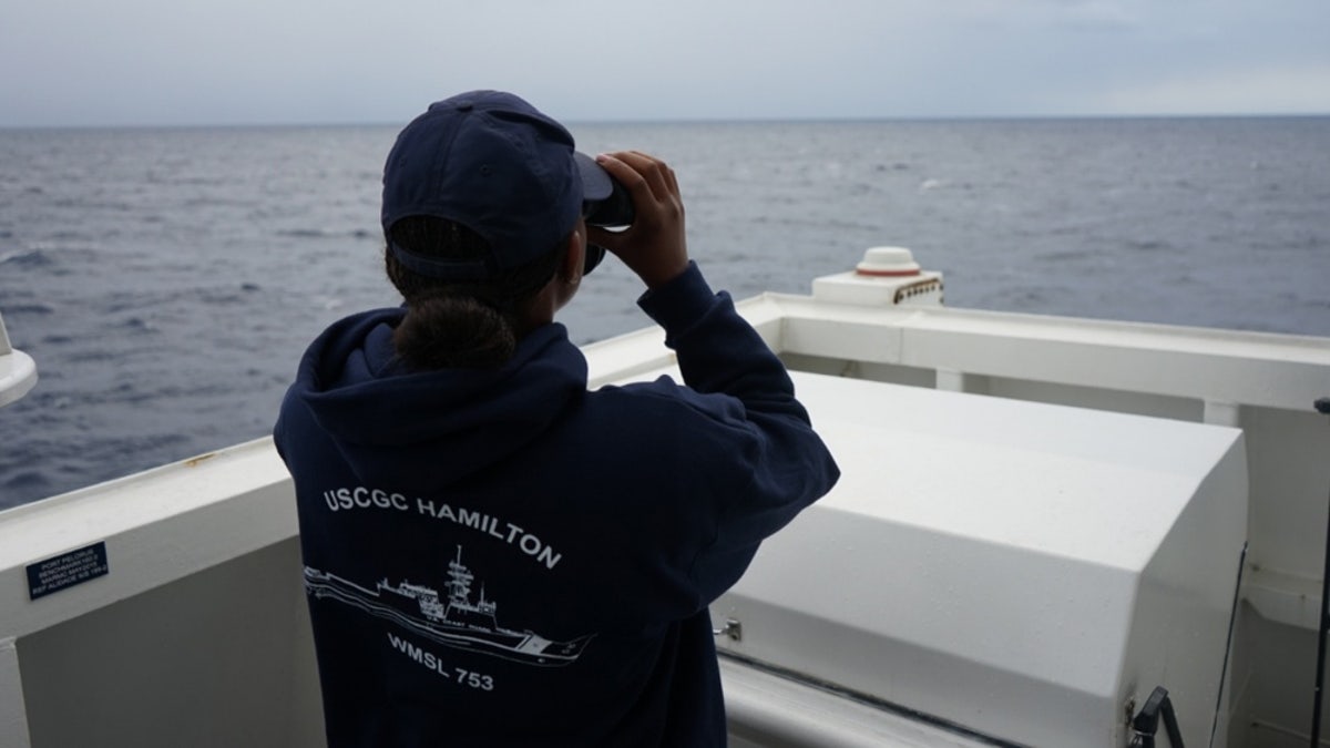 A Coast Guard Cutter Hamilton crew member searches for a downed civilian aircraft Oct. 27, 2018, 110 miles east of Charleston, South Carolina.