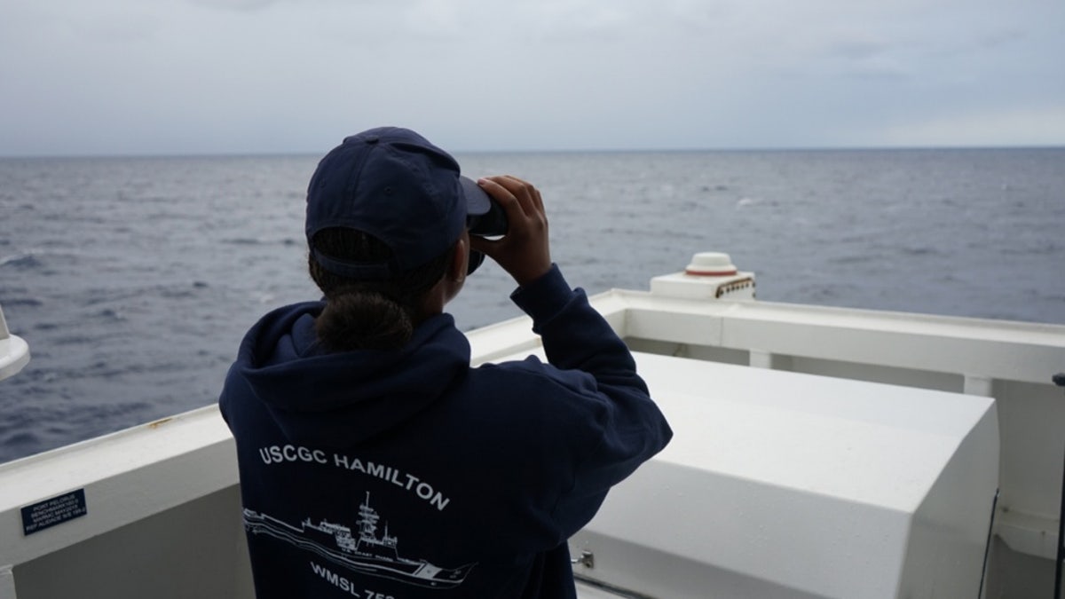 A Coast Guard Cutter Hamilton crew member searches for a downed civilian aircraft Oct. 27, 2018, 110 miles east of Charleston, South Carolina.