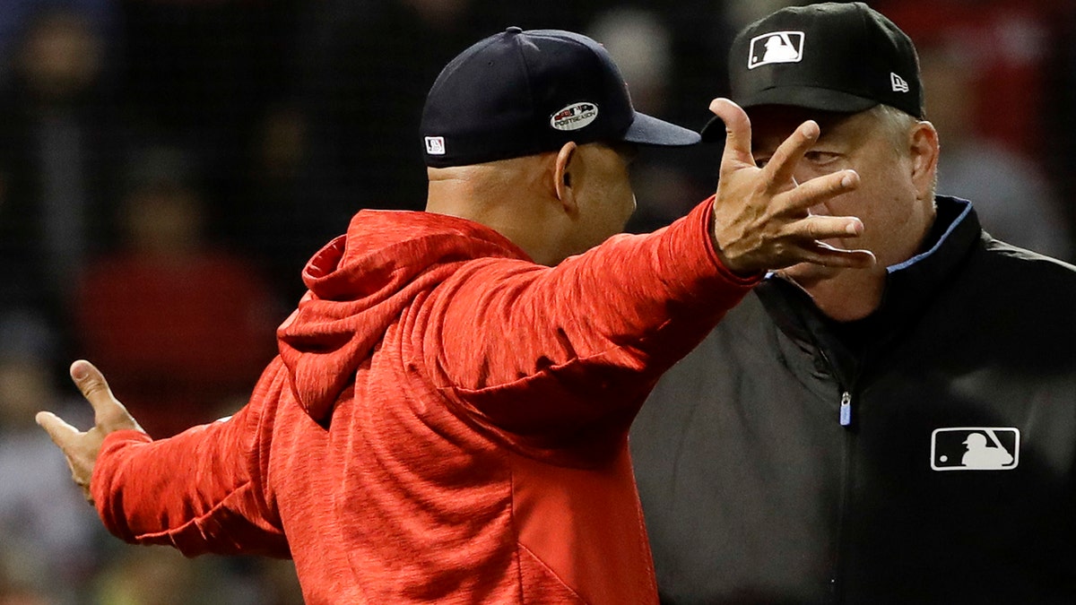Boston Red Sox manager Alex Cora, left, talks to right fielder Mookie Betts  in the dugout during the ninth inning of a baseball game against the Tampa  Bay Rays Friday, Sept. 20