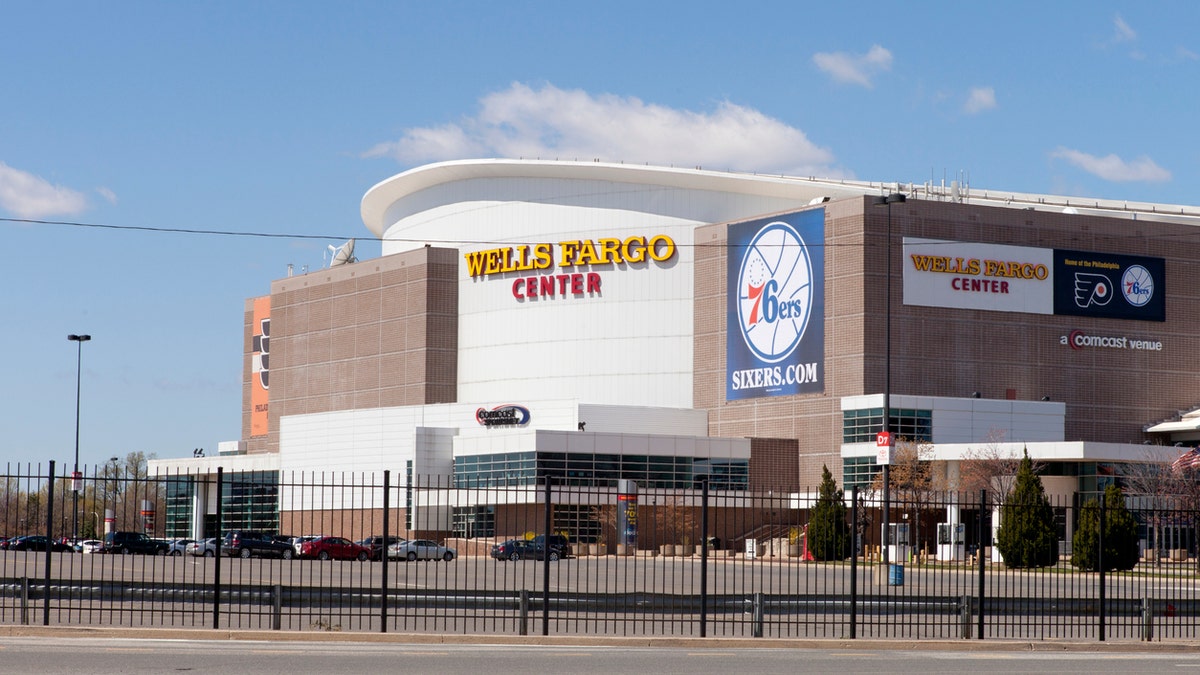 A basketball fan claims she was barred from entering because of her outift.