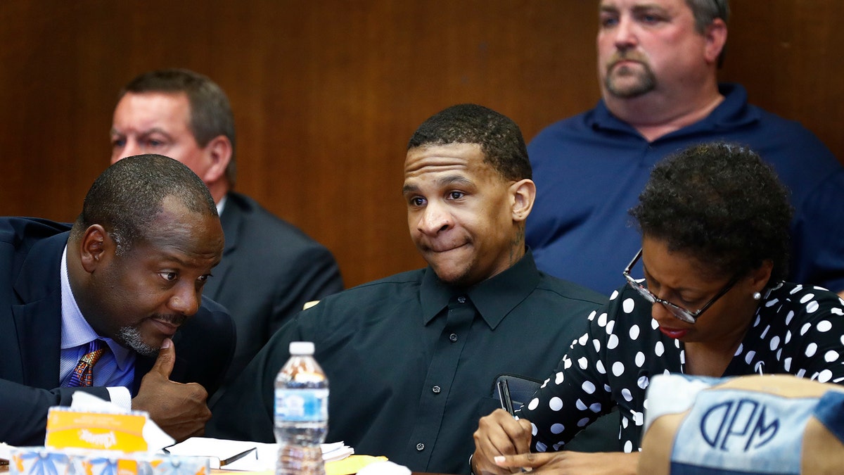 Defendant Quinton Tellis, center, looks on as the jury goes to deliberate his case.