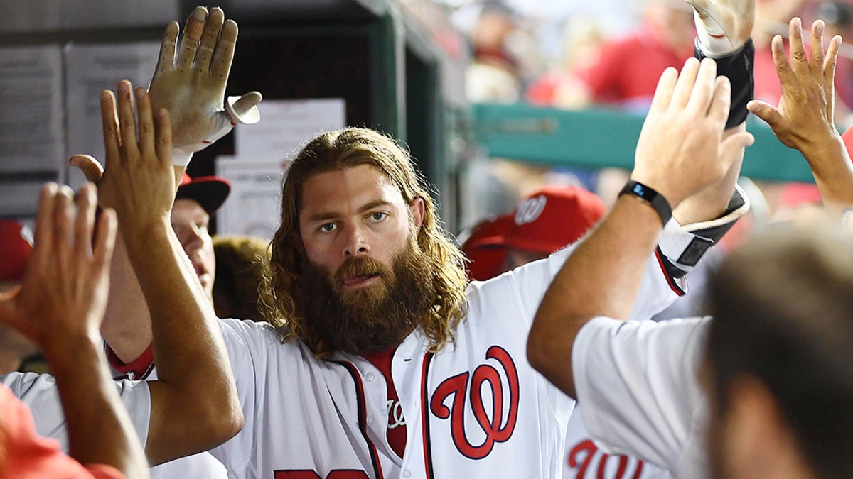 Washington Nationals left fielder Jayson Werth is congratulated by teammates after hitting a solo home against the St. Louis Cardinals during the fourth inning at Nationals Park.