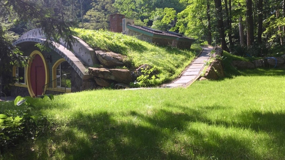 The acreage includes a small stream with walking bridge, pond, and waterfall.<br>
