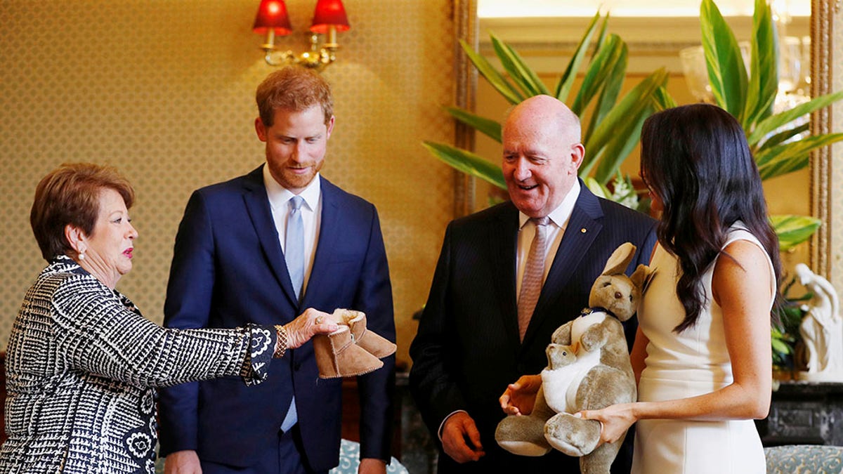 Prince Harry and Meghan Markle receive gifts from Australia's Governor General Sir Peter Cosgrove and his wife Lady Cosgrove at Admiralty House in Sydney, Australia on Oct. 16, 2018. 