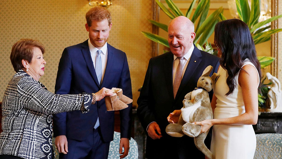 Prince Harry and Meghan Markle receive gifts from Australia's Governor General Sir Peter Cosgrove and his wife Lady Cosgrove at Admiralty House in Sydney, Australia on Oct. 16, 2018. 