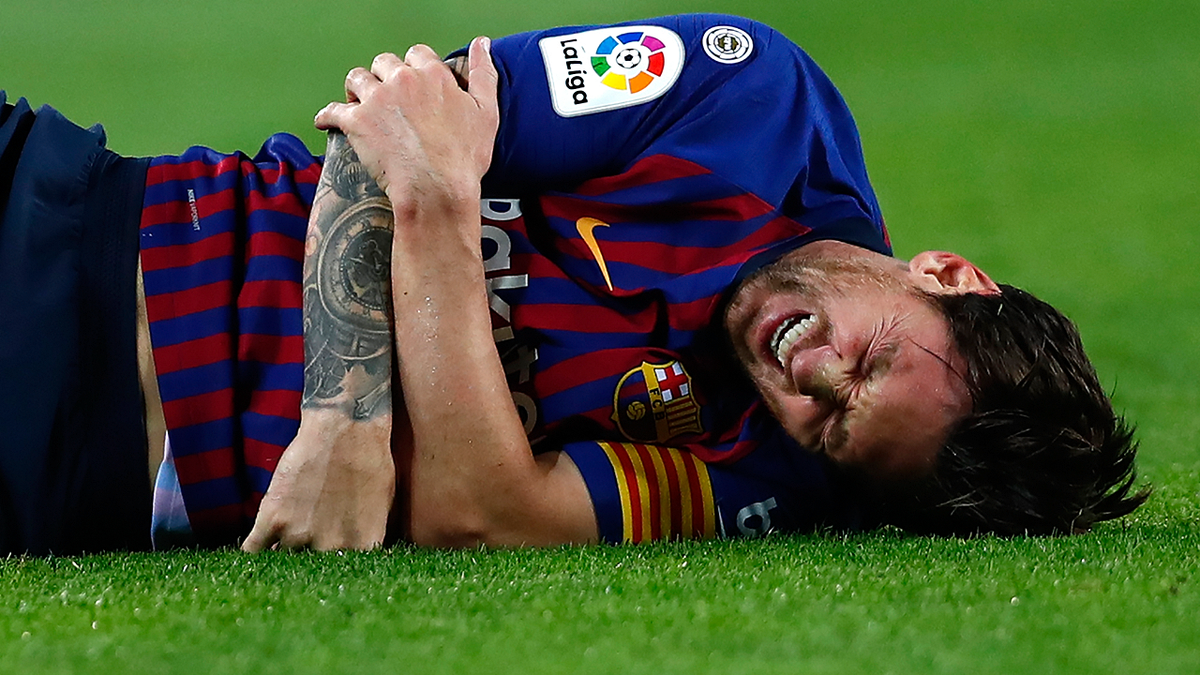 FC Barcelona's Lionel Messi looks painfully injured during the Spanish La Liga soccer match between FC Barcelona and Sevilla at the Camp Nou stadium in Barcelona, Spain, Saturday, Oct. 20, 2018.