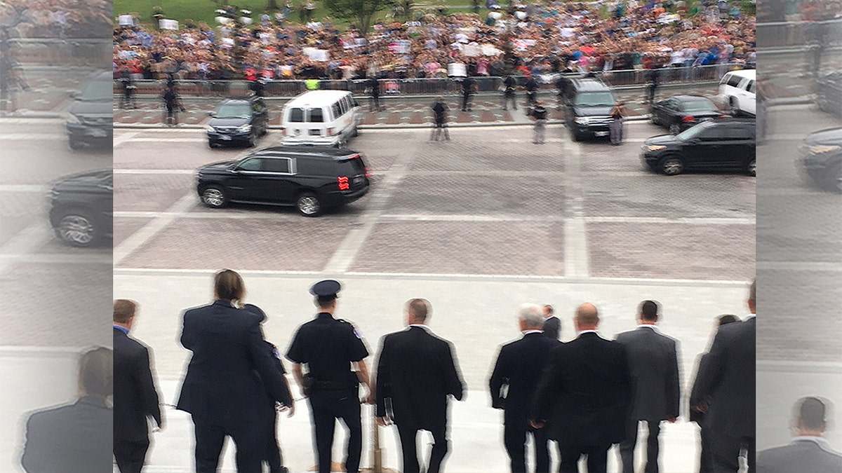 Vice President Mike Pence says “Let’s do it” and walks down Senate steps toward a?sea of protesters shouting “Shame! Shame! Shame!”