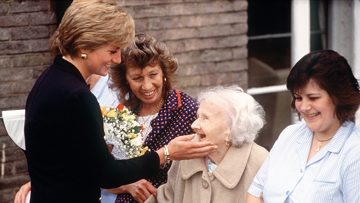 Princess Diana pictured with a gold bracelet during a visit to Lord Gage Centre For Old People, A Guinness Trust Home, In Newham, East London in 1990.