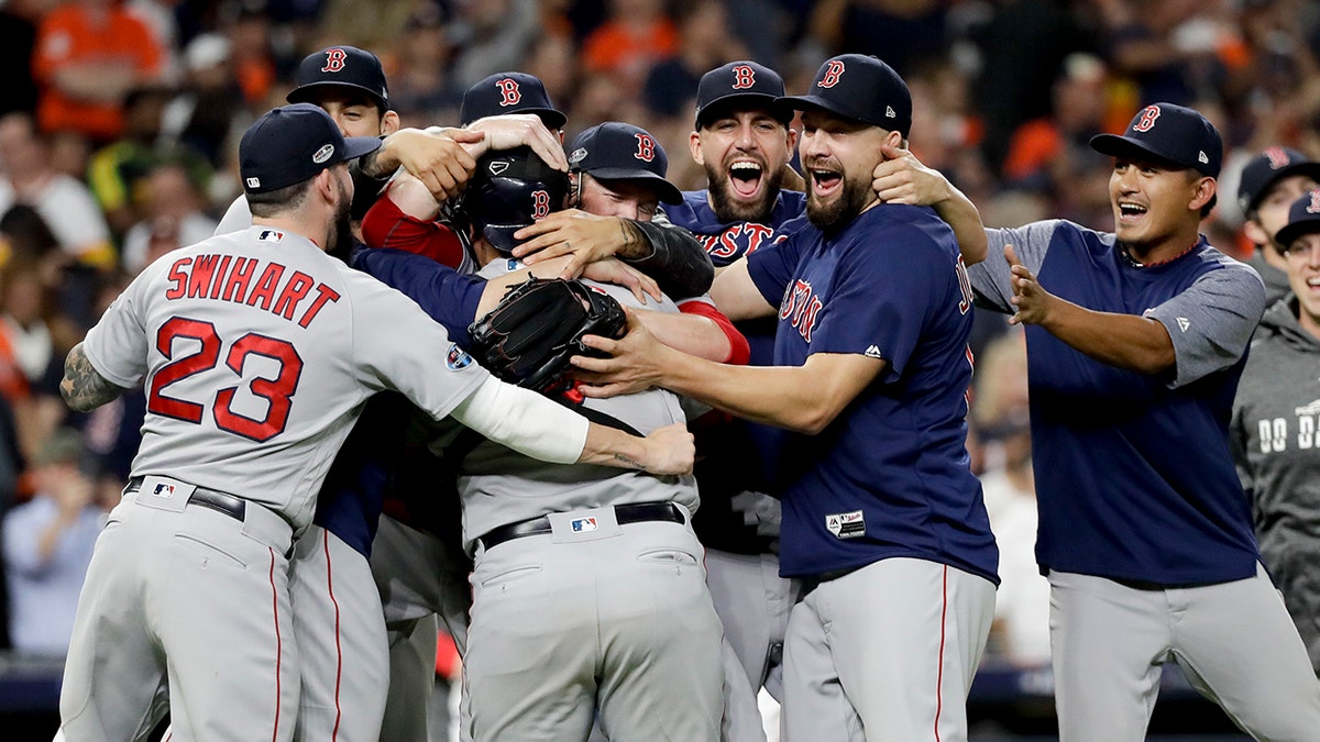 The Boston Red Sox celebrates after winning Game 5 of a baseball American League Championship Series against the Houston Astros on Thursday, Oct. 18, 2018, in Houston.