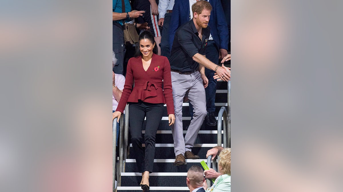 Britain's Prince Harry and Meghan, Duchess of Sussex arrive to watch the wheelchair basketball final at The Invictus Games in Sydney, Australia, Saturday, Oct. 27, 2018. Prince Harry and his wife Meghan are on day twelve of their 16-day tour of Australia and the South Pacific.(AP Photo)