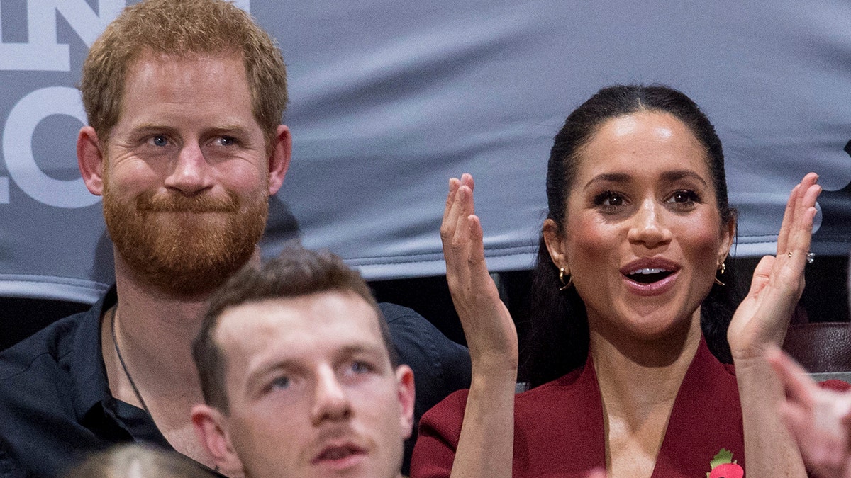 Britain's Prince Harry and Meghan, Duchess of Sussex applaud as they watch the wheelchair basketball final at The Invictus Games in Sydney, Australia, Saturday, Oct. 27, 2018. Prince Harry and his wife Meghan are on day twelve of their 16-day tour of Australia and the South Pacific. (AP Photo)
