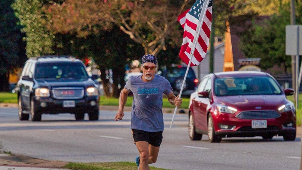 Virginia man Wayne Parfitt runs with the flag in hand to honor his son, who is deployed overseas.