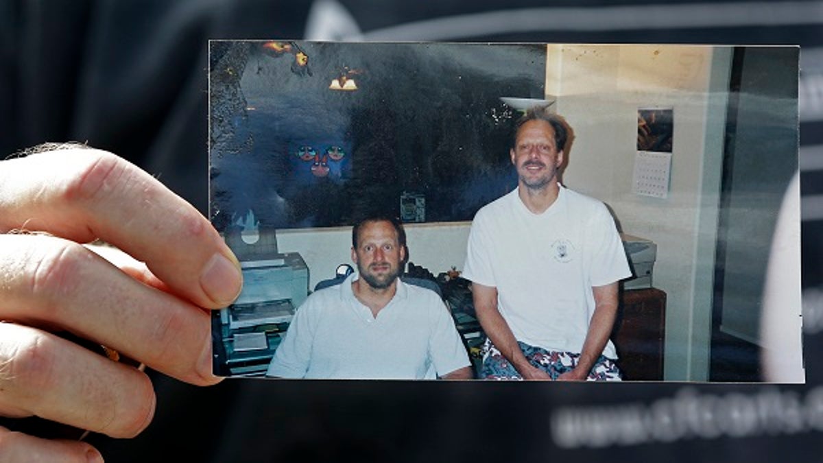  Eric Paddock holds a photo of himself, at left, and his brother, Las Vegas shooter Stephen Paddock. 
