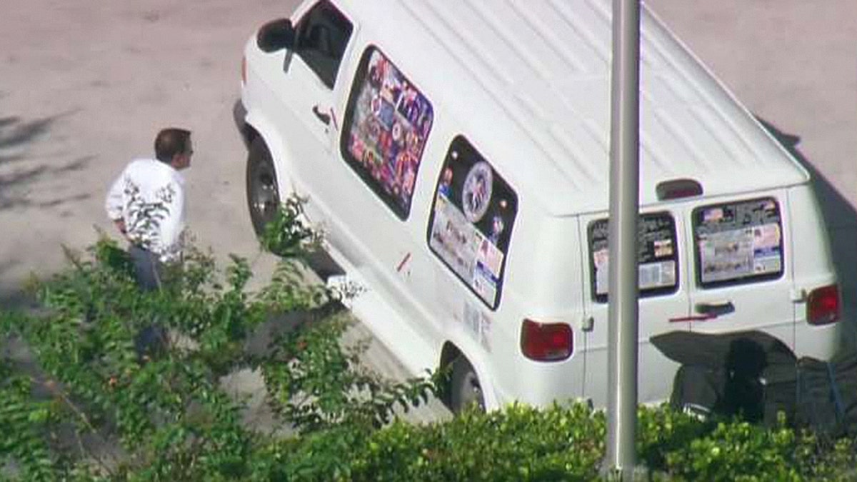Authorities in Florida investigate a van believed to belong to the suspect