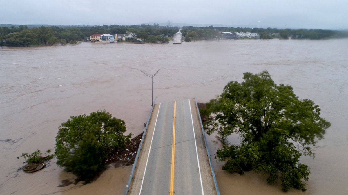 The Llano River flows between the washed out Ranch Road 2900 bridge in Kingsland, Texas.