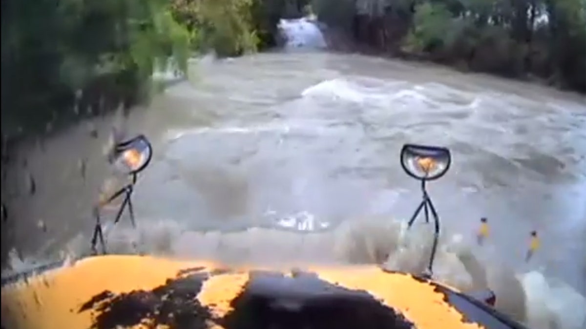 In the video, Young can be seen attempting to drive through floodwaters before the bus is washed off the road.