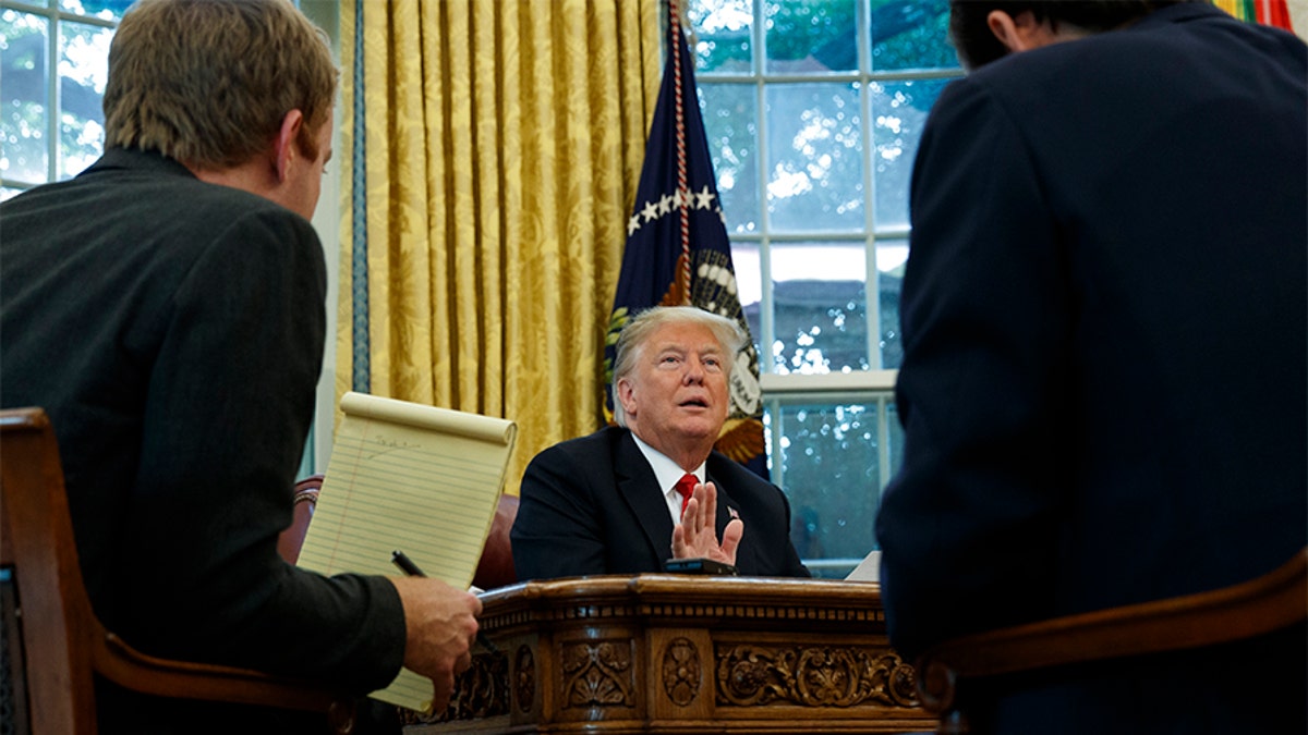 President Donald Trump speaks during an interview with The Associated Press in the Oval Office of the White House on Tuesday in Washington.