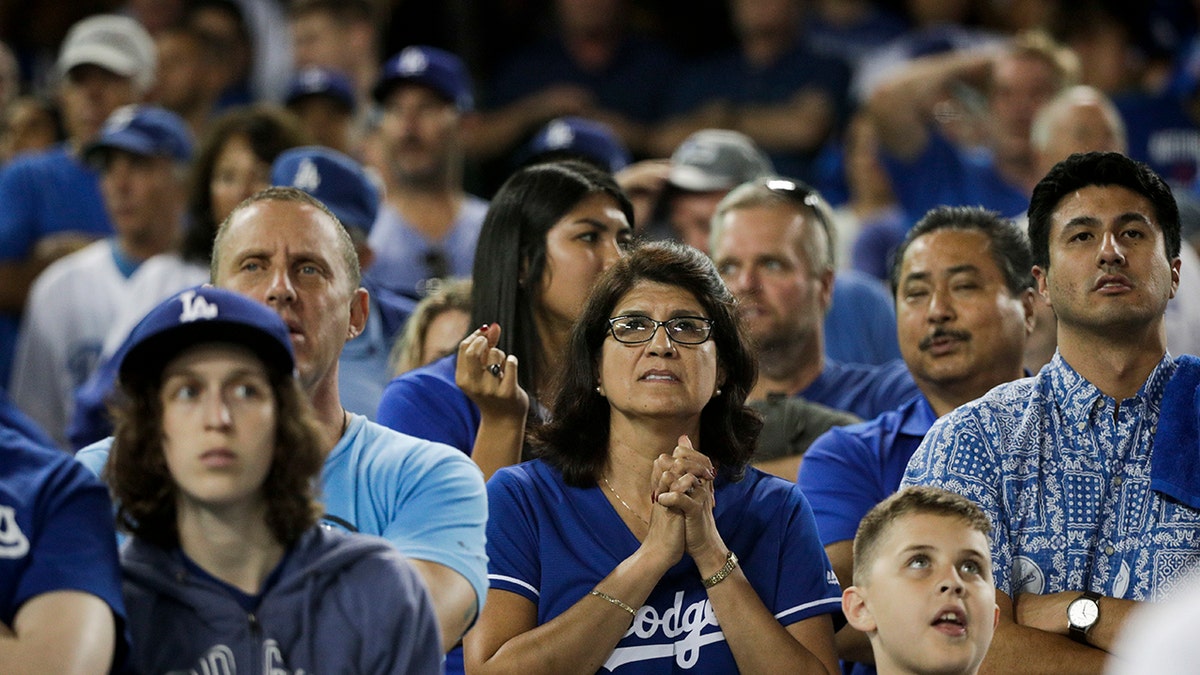 Los Angeles Dodgers fans watch during the 13th inning in Game 3 of the World Series baseball game against the Boston Red Sox on Friday, Oct. 26, 2018, in Los Angeles. (Associated Press)