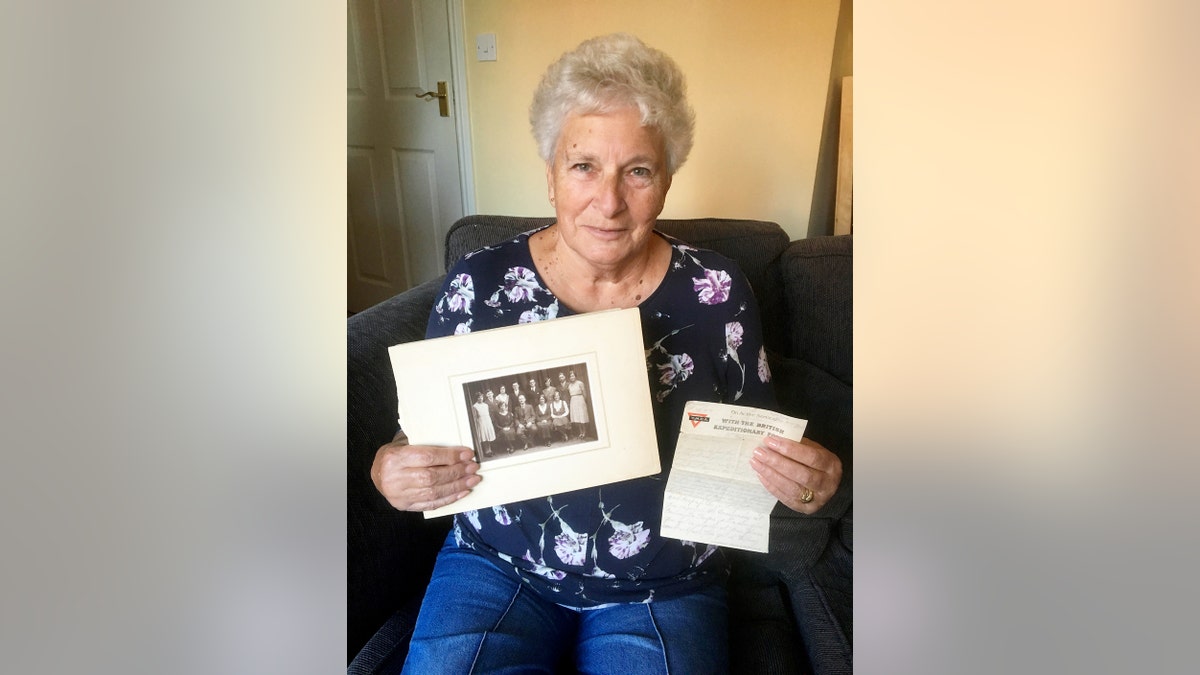 Christine Spall, with the letter and family photograph. (Credit: SWNS)