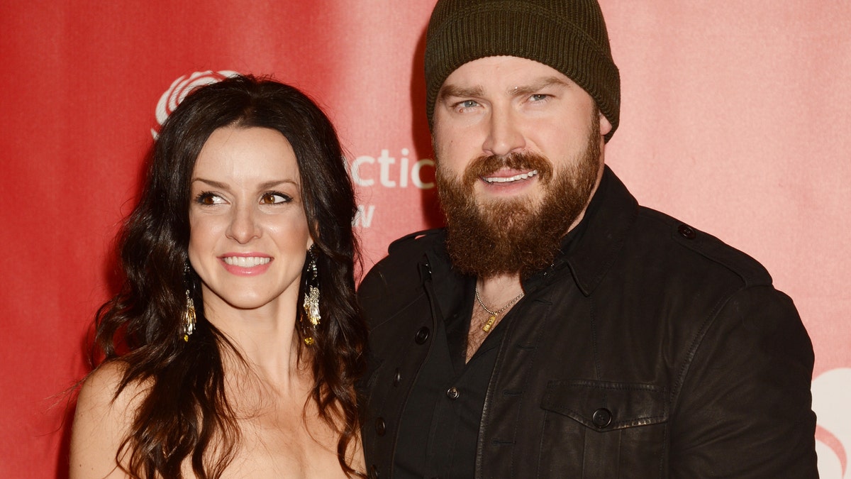 Singer Zac Borwn (R) and Shelly Brown attends the 2013 MusiCares Person Of The Year Honoring Bruce Springsteen at Los Angeles Convention Center on February 8, 2013 in Los Angeles, California.