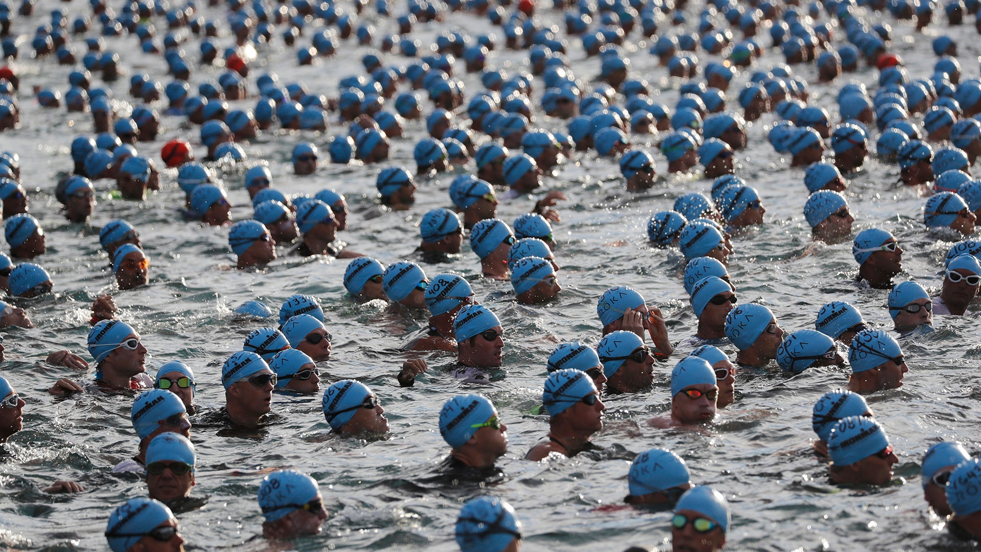 Competitors wait for the start of the swimming race at the Ironman Triathlon World Championship in Kailua Kona, Hawaii, Oct. 13, 2018.