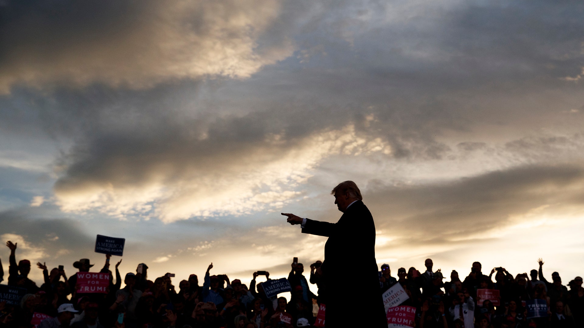President Donald Trump arrives as the sun sets to speak at a campaign rally at Minuteman Aviation Hangar, in Missoula, Montana, Oct. 18, 2018.