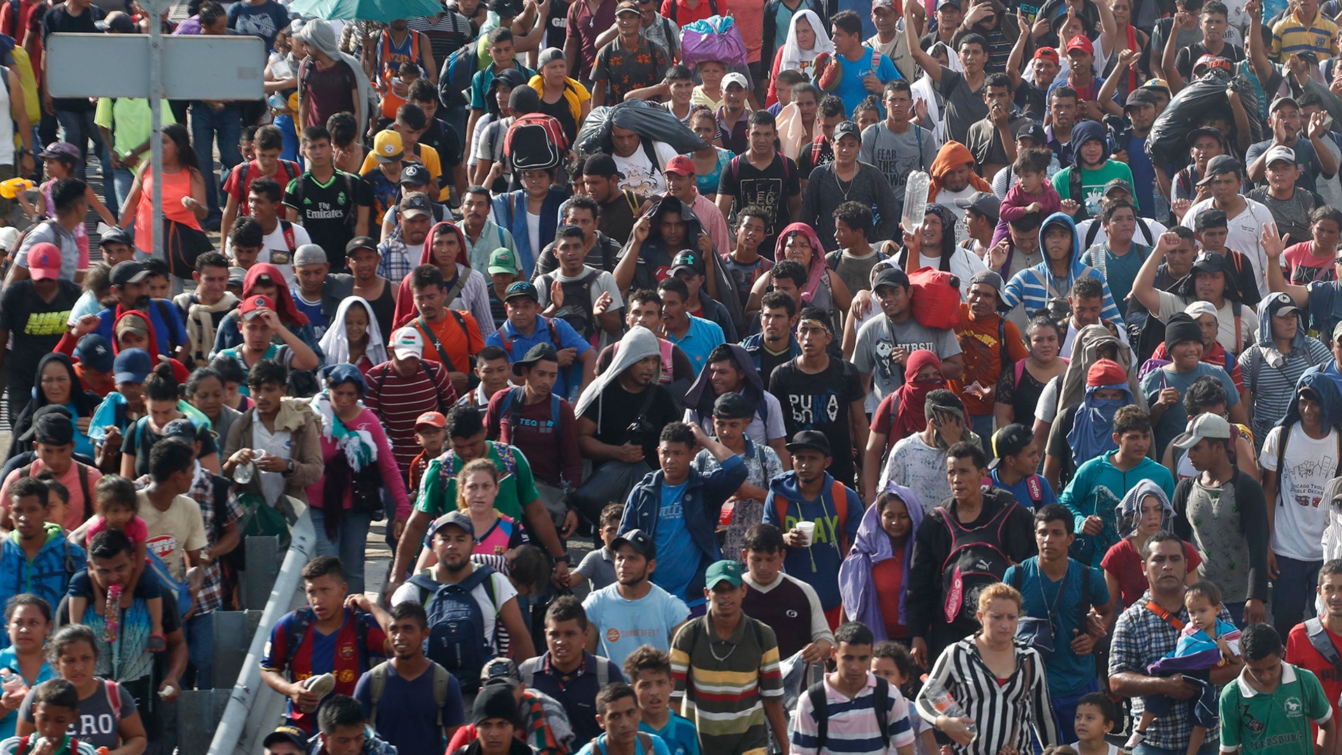 Central American migrants walking to the United States start their day departing Ciudad Hidalgo, Mexico, on Oct. 21, 2018. 