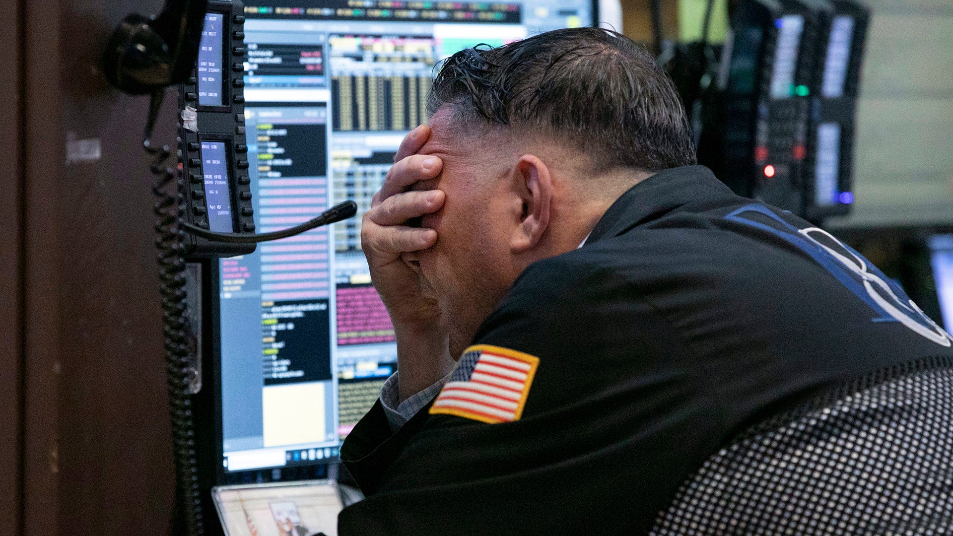 Trader Jonathan Mueller works in his booth on the floor of the New York Stock Exchange, Oct. 26, 2018.  