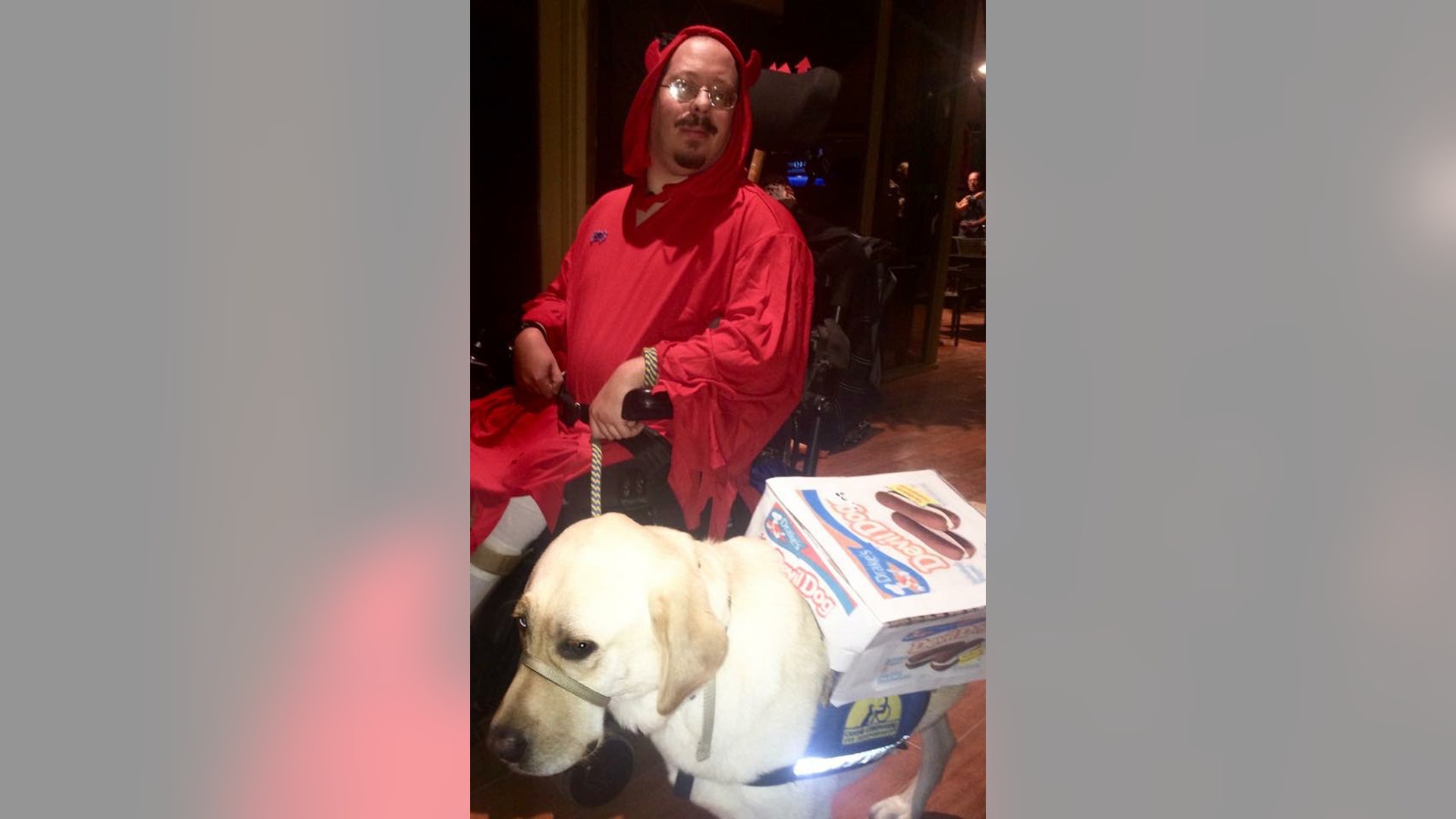 These two are devilishly good — Bob Fliegel and his Canine Companions for Independence service dog Hardy as the devil and the devil dog.