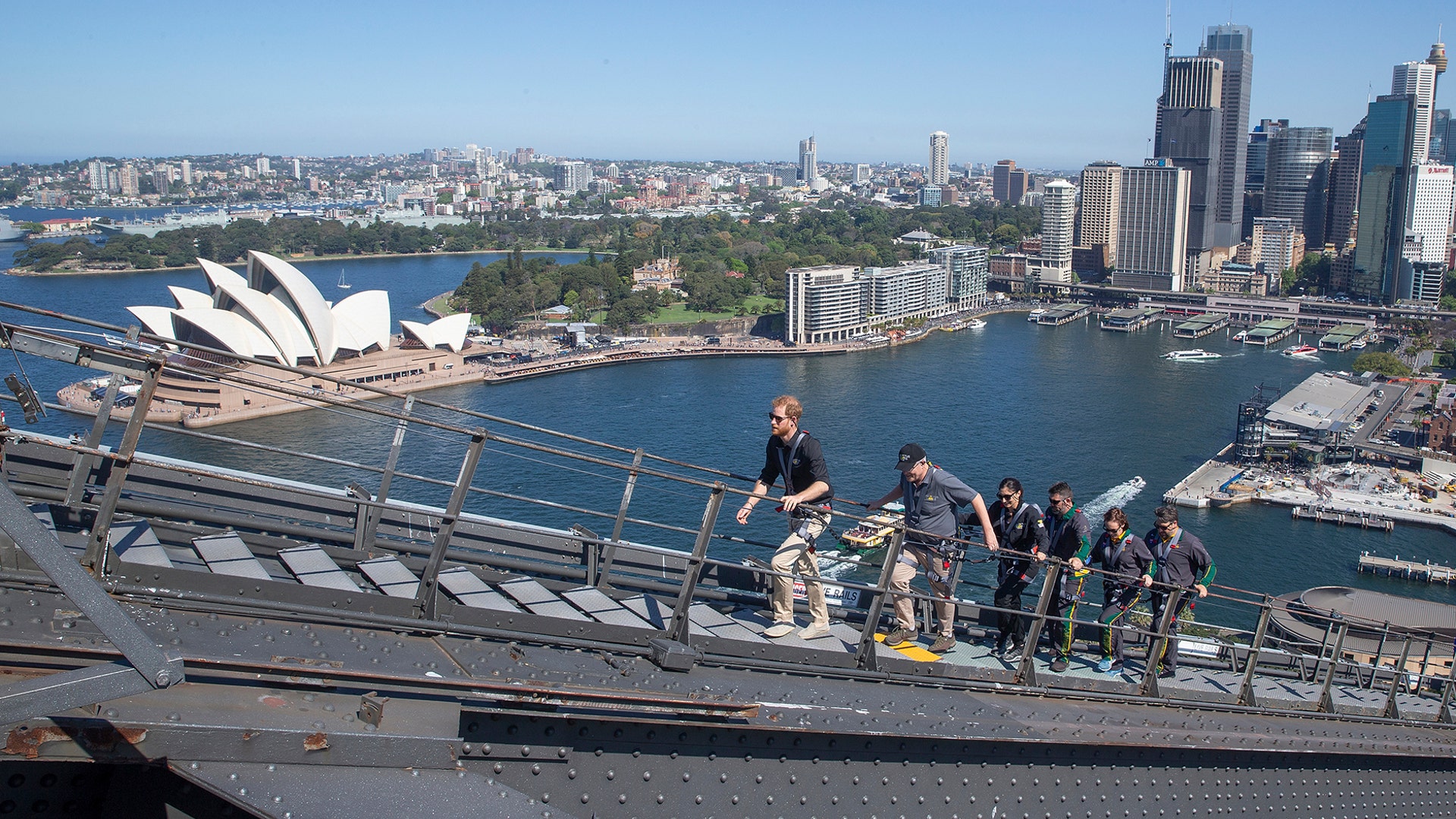 Britain's Prince Harry, Australia's Prime Minister Scott Morrison, and Invictus Games representatives climb the Sydney Harbour Bridge in Sydney, Oct. 19, 2018. 