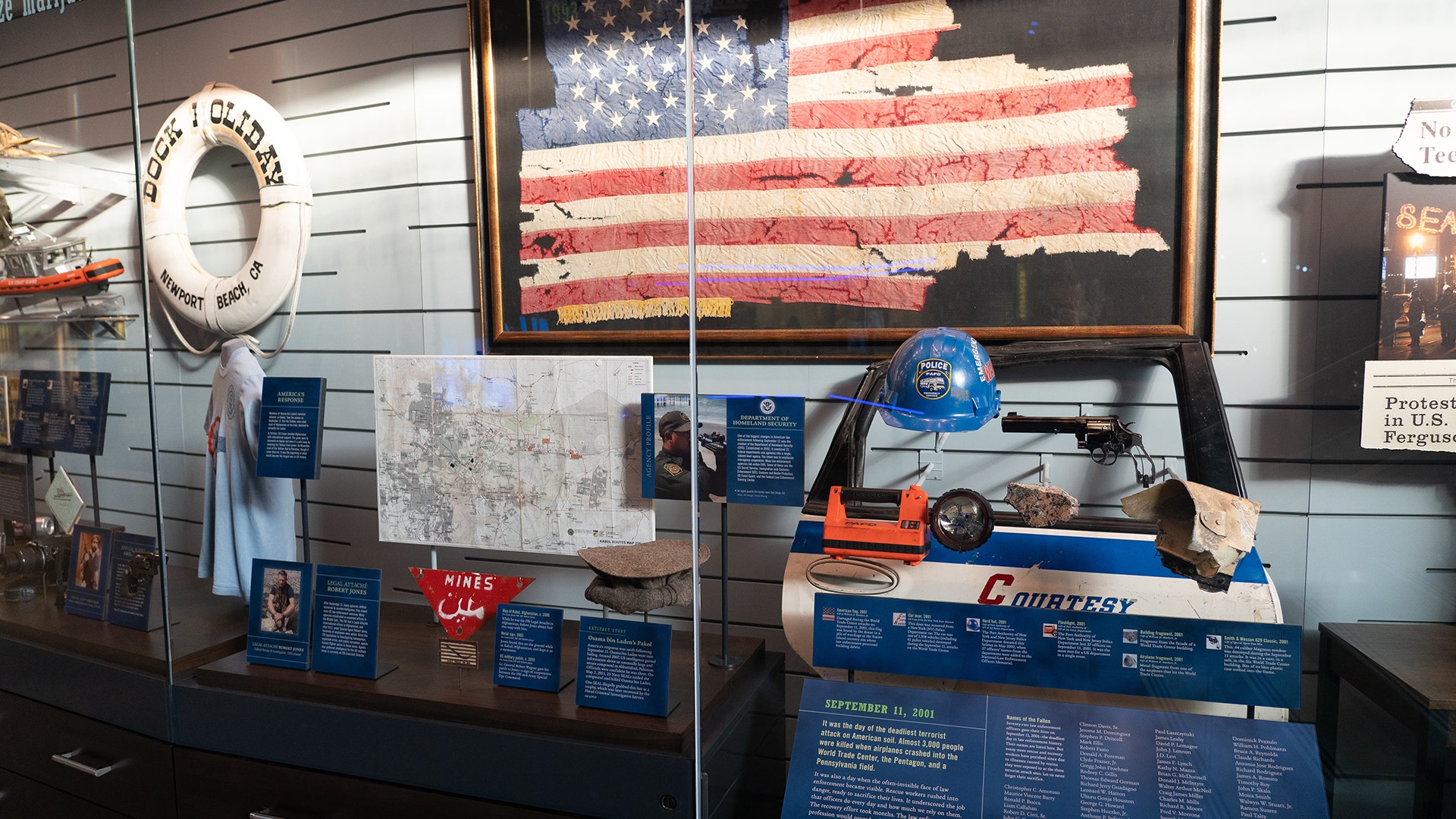 A flag recovered from the rubble of the World Trade Center hangs above artifacts from the September 11 attacks.