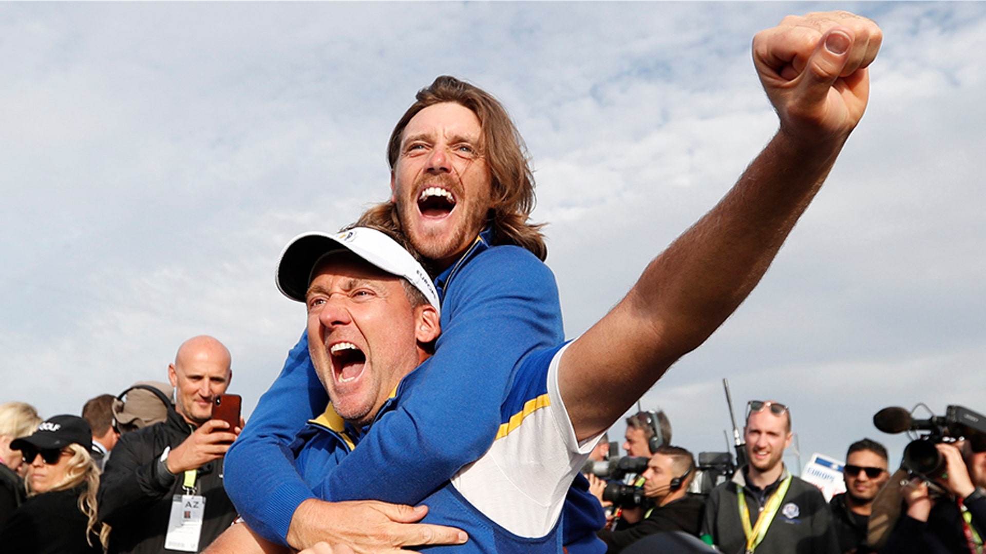 Team Europe's Ian Poulter celebrates with Tommy Fleetwood after winning the Ryder Cupat the Le Golf National in Guyancourt, France, Sept. 30, 2018.