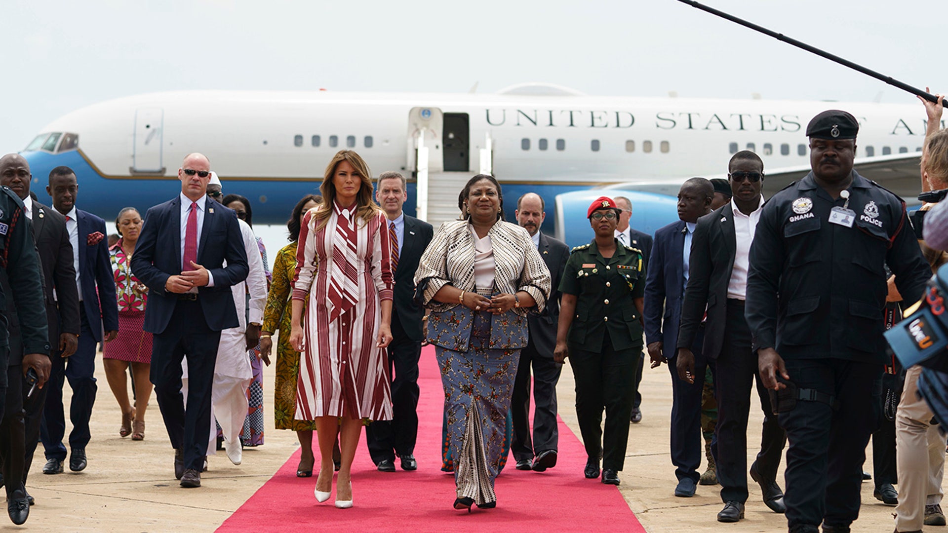 First lady Melania Trump walks with Ghana's first lady Rebecca Akufo-Addo as she arrives at Kotoka International Airport in Accra, Ghana, Tuesday, Oct. 2, 2018. (AP Photo/Carolyn Kaster)