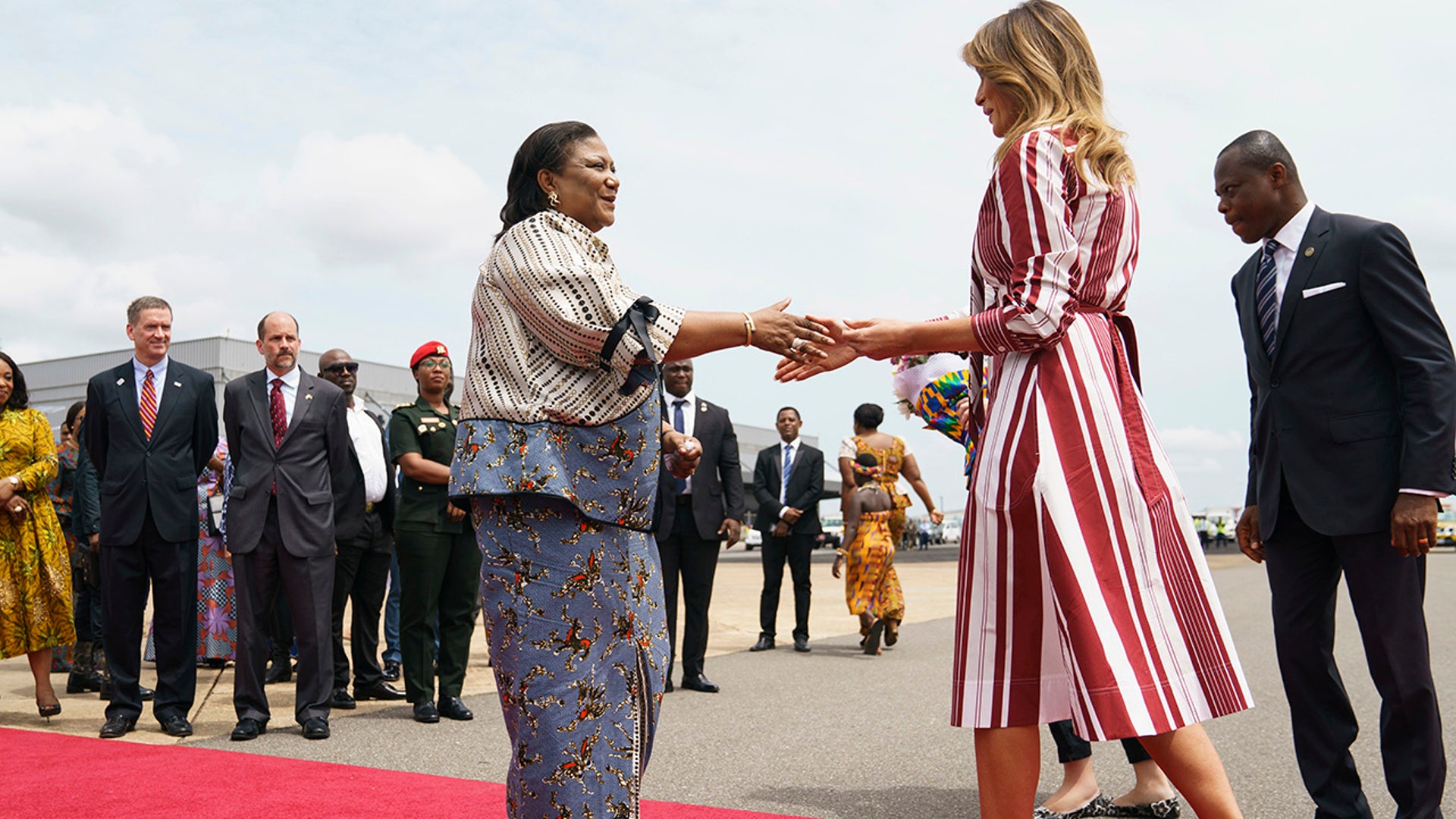 First lady Melania Trump is greeted by Ghana's first lady Rebecca Akufo-Addo as she arrives at Kotoka International Airport in Accra, Ghana, Tuesday, Oct. 2, 2018.  (AP Photo/Carolyn Kaster)