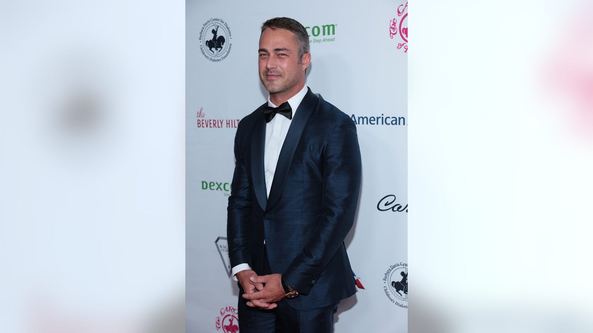 Taylor Kinney looks dapper in a blue suit while stepping out for the 2018 Carousel of Hope Ball at the Beverly Hilton Hotel in Beverly Hills, Calif. on October 6, 2018.

