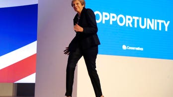 British prime minister Theresa May dances on stage to ABBA at Conservative conference