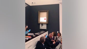 Banksy painting renamed 'Love is in the Bin' after shredding during live auction
