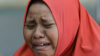 The Latest: Volunteers bury more bodies from Indonesia quake
