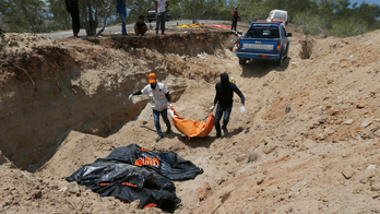 High above Indonesian city, a mass grave and many questions