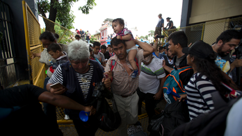 The Latest: Mexico says 2 buses arrive at border crossing