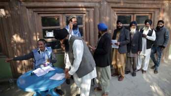 The Latest: Afghan official outraged by polls' chaotic start