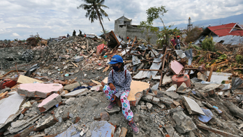 Confirmed deaths near 2,000, still more likely in Indonesia