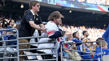Saints fan helps disabled Giants fan stand for national anthem in viral photo