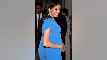 Meghan Markle cradles baby bump in cape evening gown at Fiji state dinner
