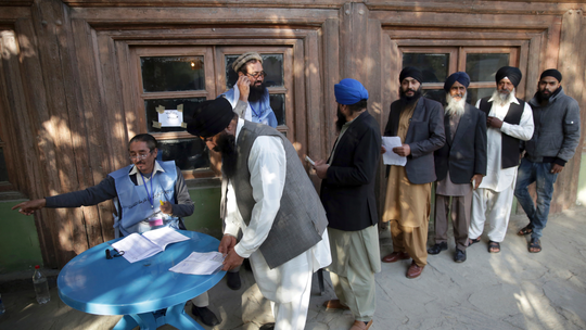 The Latest: Afghan official outraged by polls' chaotic start