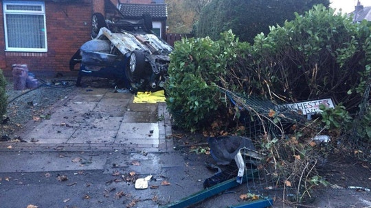 Car flips into driveway and catches fire as driver goes on the run
