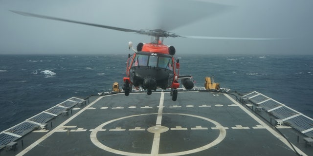 A Coast Guard rescue helicopter takes off from the deck of the Cutter Hamilton to continue searching for a missing civilian aircraft Oct. 27, 2018, 110 miles east of Charleston, South Carolina.