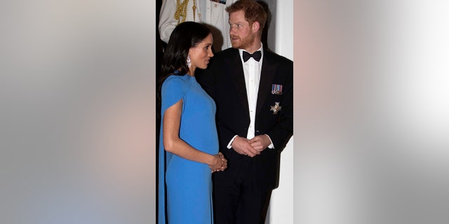 Britain's Prince Harry and Meghan, Duchess of Sussex at the official dinner in Suva, Fiji, Tuesday, Oct. 23, 2018. Prince Harry and his wife Meghan are on day eight of their 16-day tour of Australia and the South Pacific.